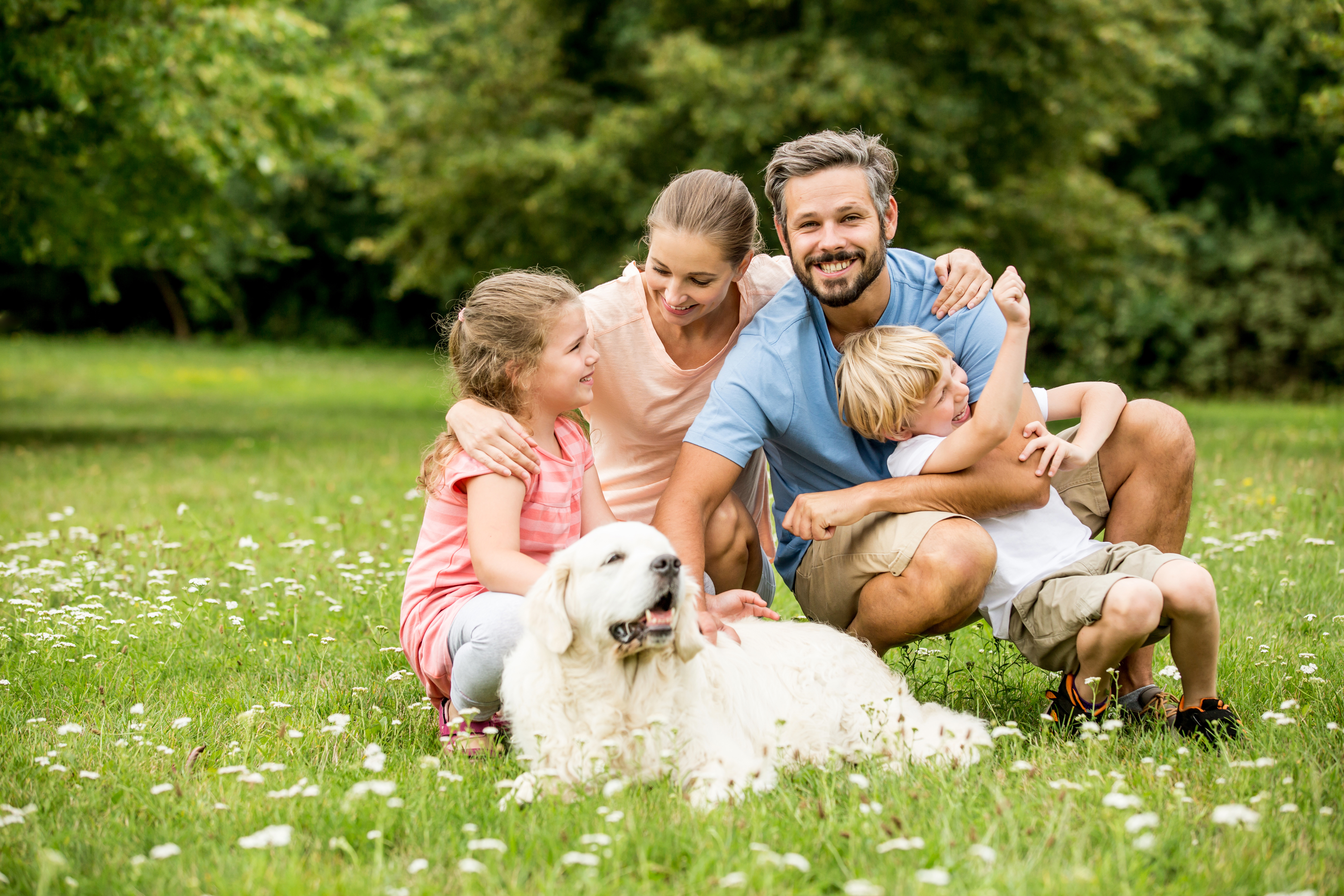 dog-familiy-garden happy dog with his family and kids in the garden.